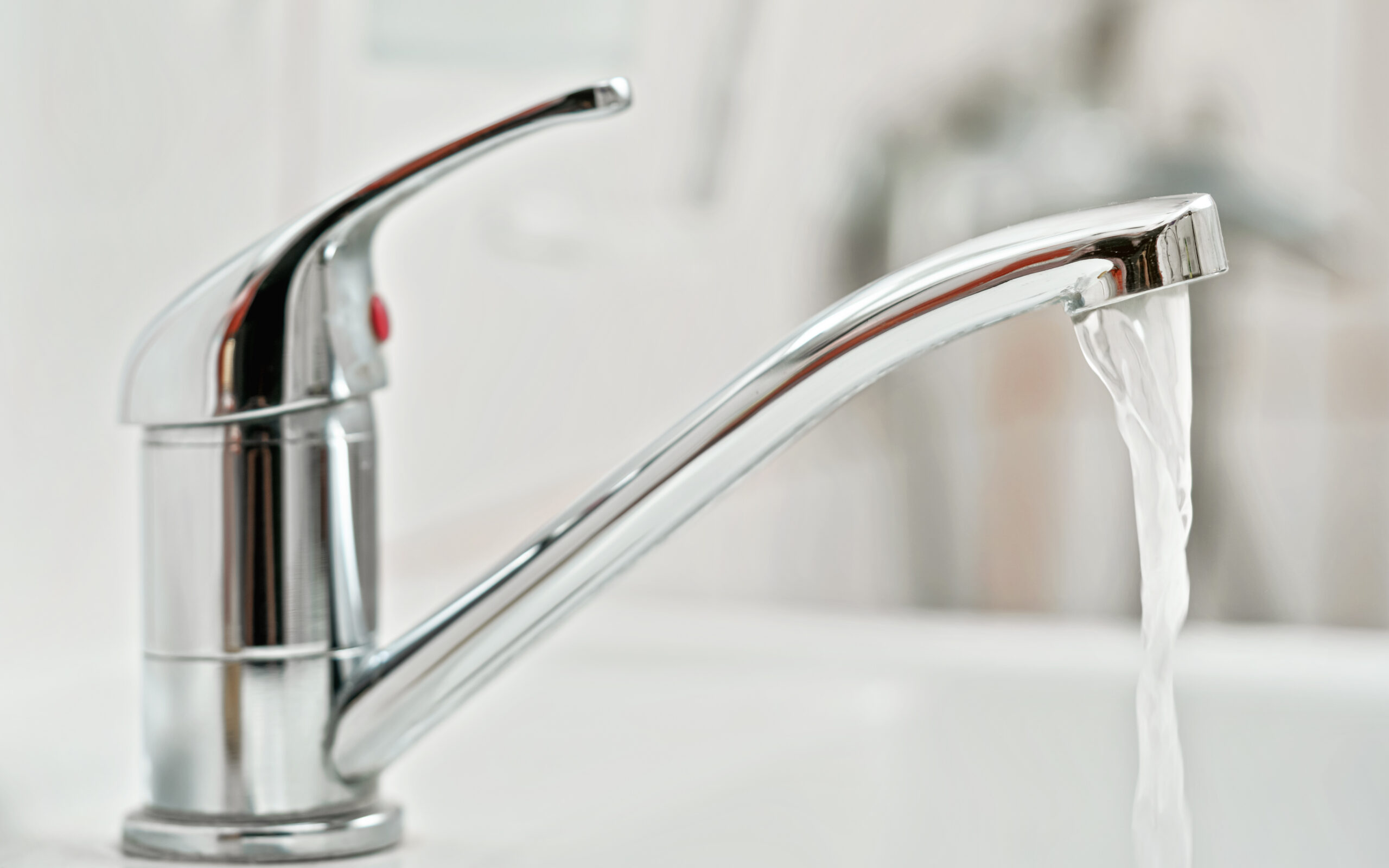 Image of tap water faucet with running water